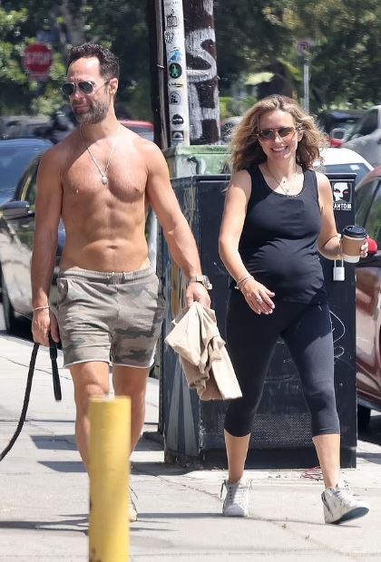 Becki Newton showing her pregnant belly