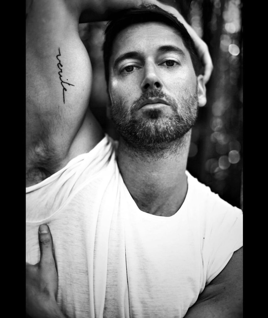Ryan Eggold showing off the tattoo on his arm